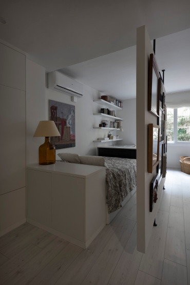 Diseño de dormitorio tipo loft contemporáneo pequeño con paredes blancas, suelo de madera clara y suelo blanco