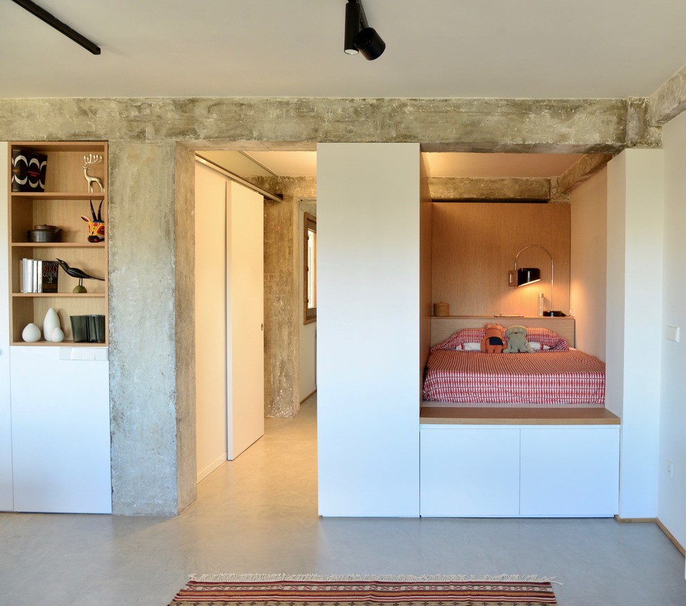 Medium sized industrial mezzanine bedroom in Other with white walls, concrete flooring and grey floors.