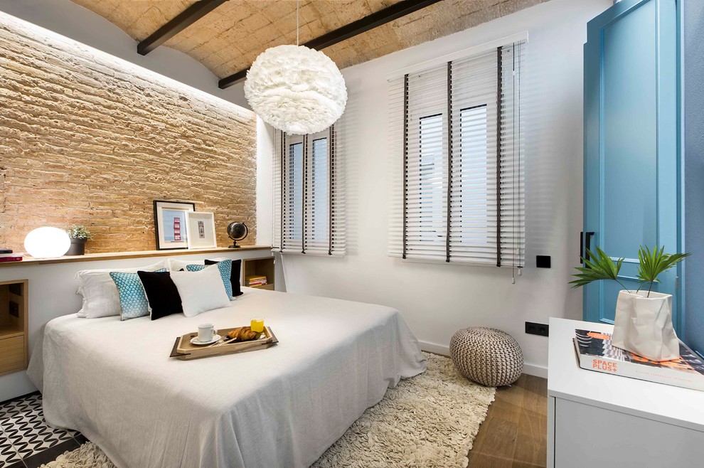 This is an example of a medium sized mediterranean master bedroom in Barcelona with no fireplace and beige walls.