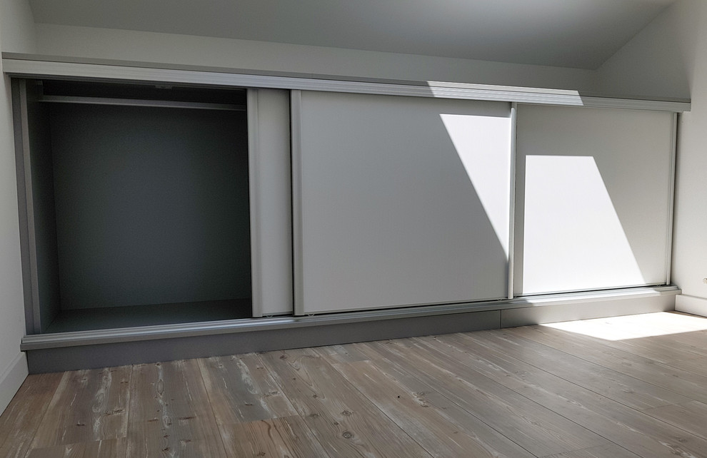 Photo of a small classic gender neutral standard wardrobe in Other with lino flooring and brown floors.