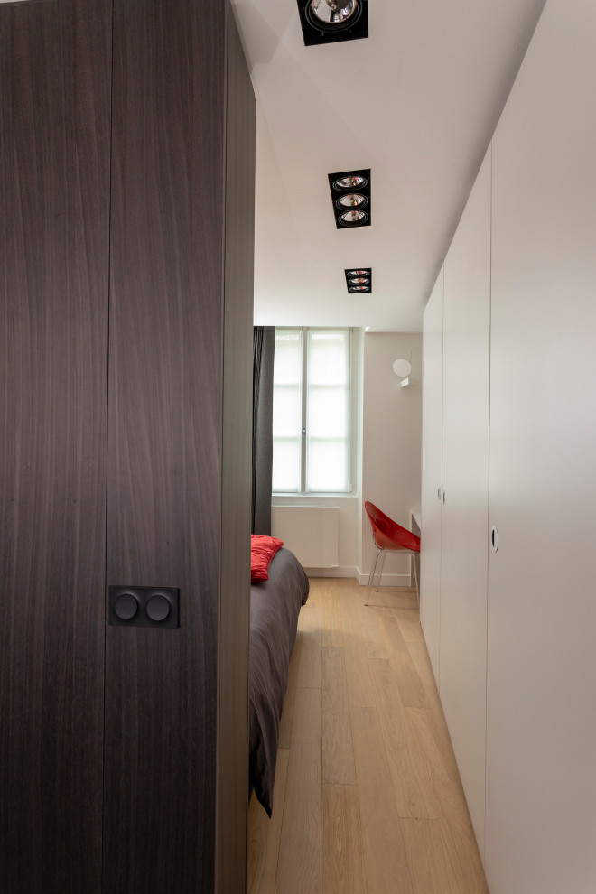Mittelgroßes, Neutrales Modernes Ankleidezimmer mit Einbauschrank, Kassettenfronten, grauen Schränken, hellem Holzboden und beigem Boden in Sonstige