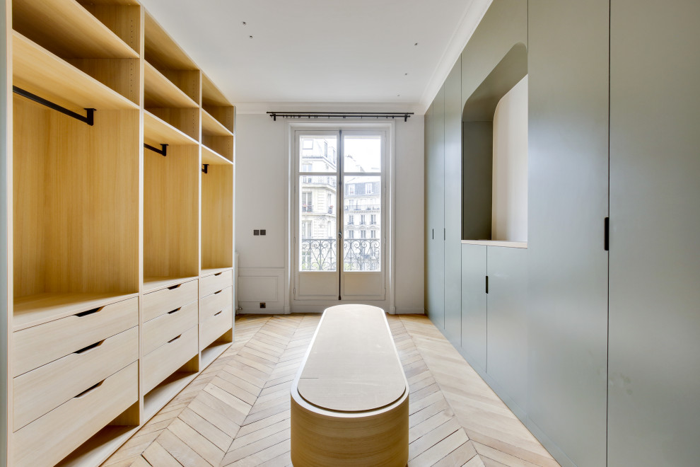 パリにあるラグジュアリーな広いトランジショナルスタイルのおしゃれなフィッティングルーム (インセット扉のキャビネット、淡色木目調キャビネット、無垢フローリング、茶色い床) の写真