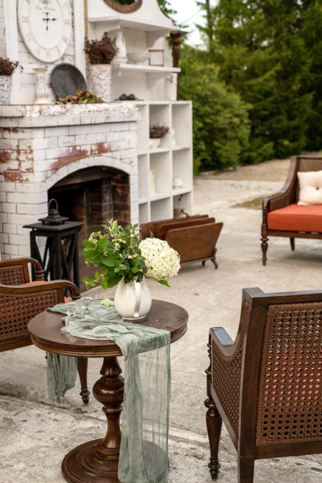 This is an example of a large victorian back patio in Moscow with a fireplace.