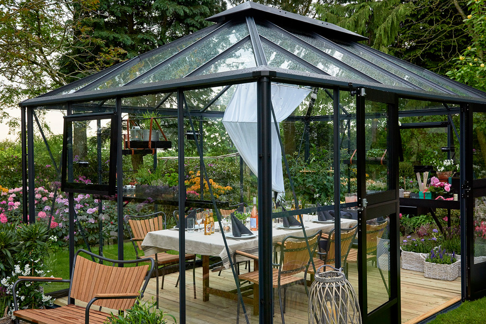 Design ideas for a contemporary back patio in Moscow with a gazebo.