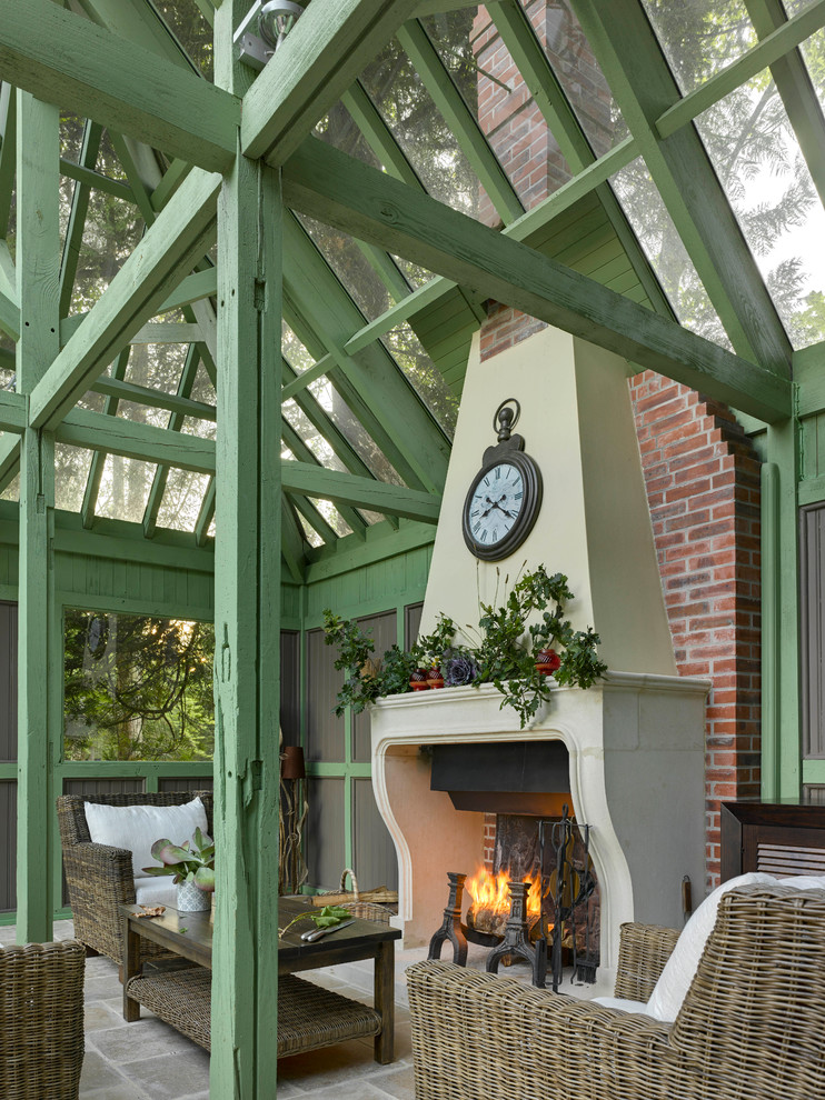 Ejemplo de patio tradicional de tamaño medio con adoquines de piedra natural, pérgola y chimenea