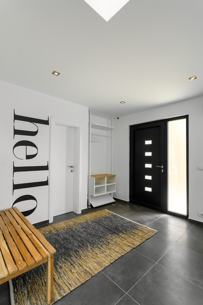 This is an example of a large contemporary foyer in Other with white walls, ceramic flooring, a single front door, a metal front door and grey floors.