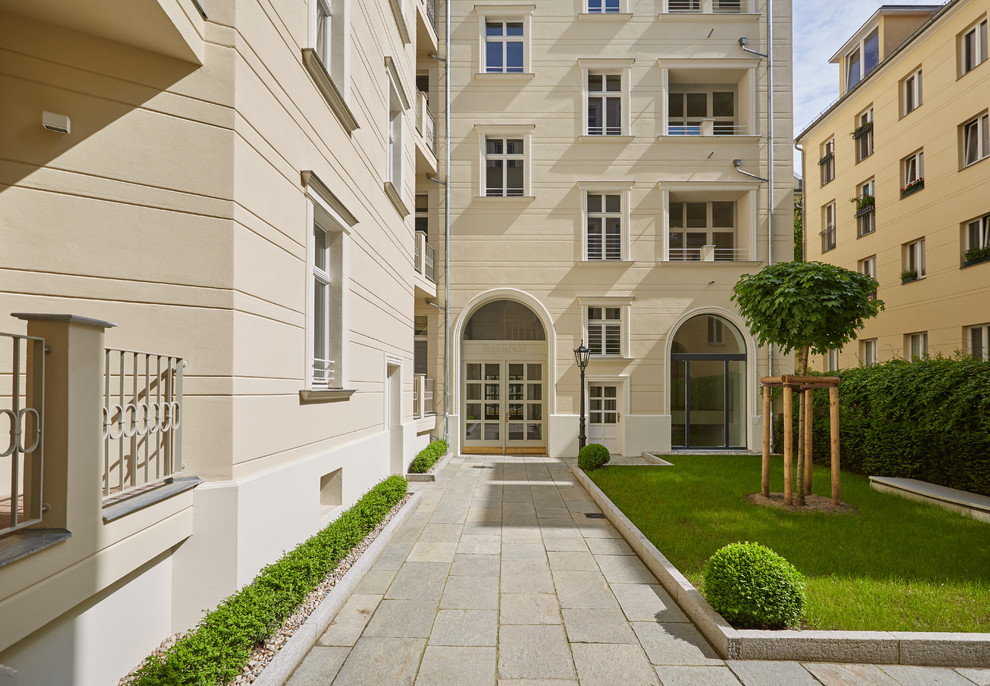 Example of a large classic gray floor entryway design in Berlin with beige walls