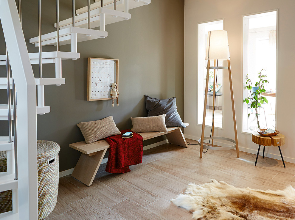 Inspiration for a medium sized scandinavian foyer in Other with green walls, beige floors and a feature wall.