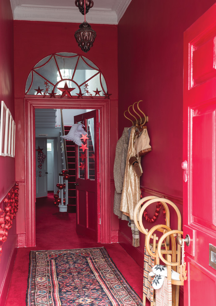 Ispirazione per un piccolo ingresso o corridoio tradizionale con pareti rosse e moquette
