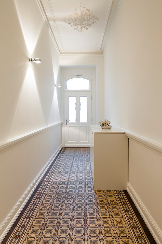 Design ideas for a medium sized classic hallway in Bonn with white walls, a single front door, a white front door and multi-coloured floors.