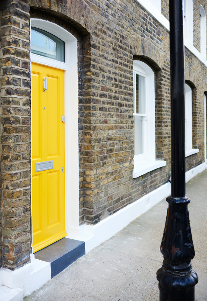Mittelgroße Nordische Haustür mit bunten Wänden, Betonboden, Einzeltür, gelber Tür und grauem Boden in London