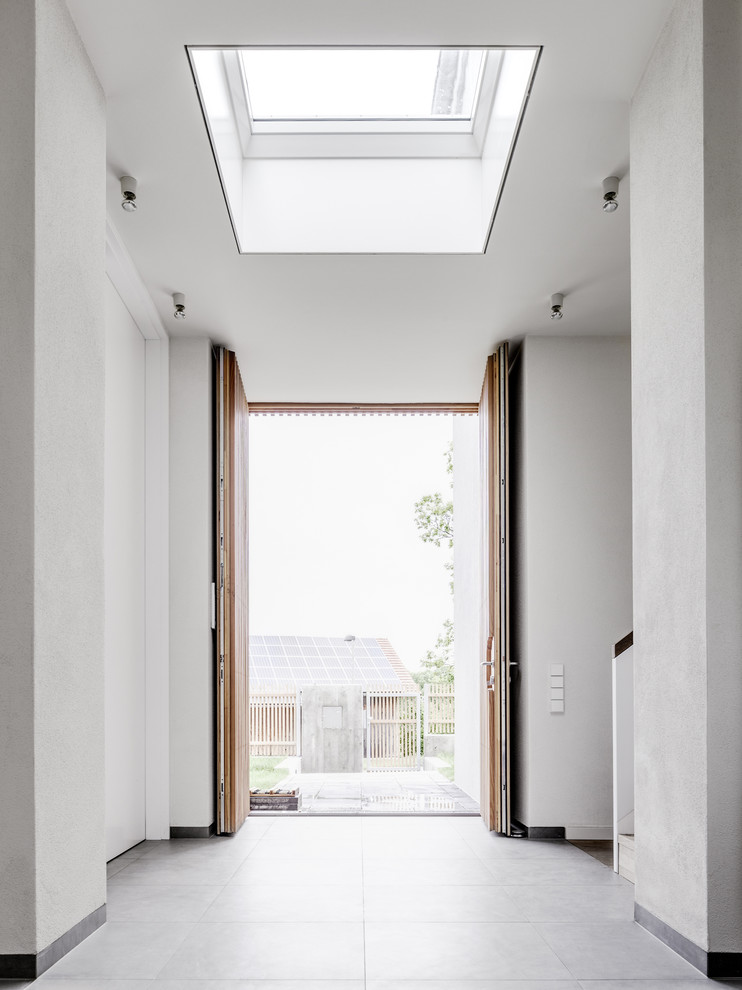 Large contemporary front door in Berlin with white walls, a double front door and a light wood front door.