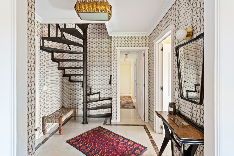 Entryway - mid-sized eclectic marble floor, beige floor, tray ceiling and wallpaper entryway idea in Madrid with multicolored walls and a white front door
