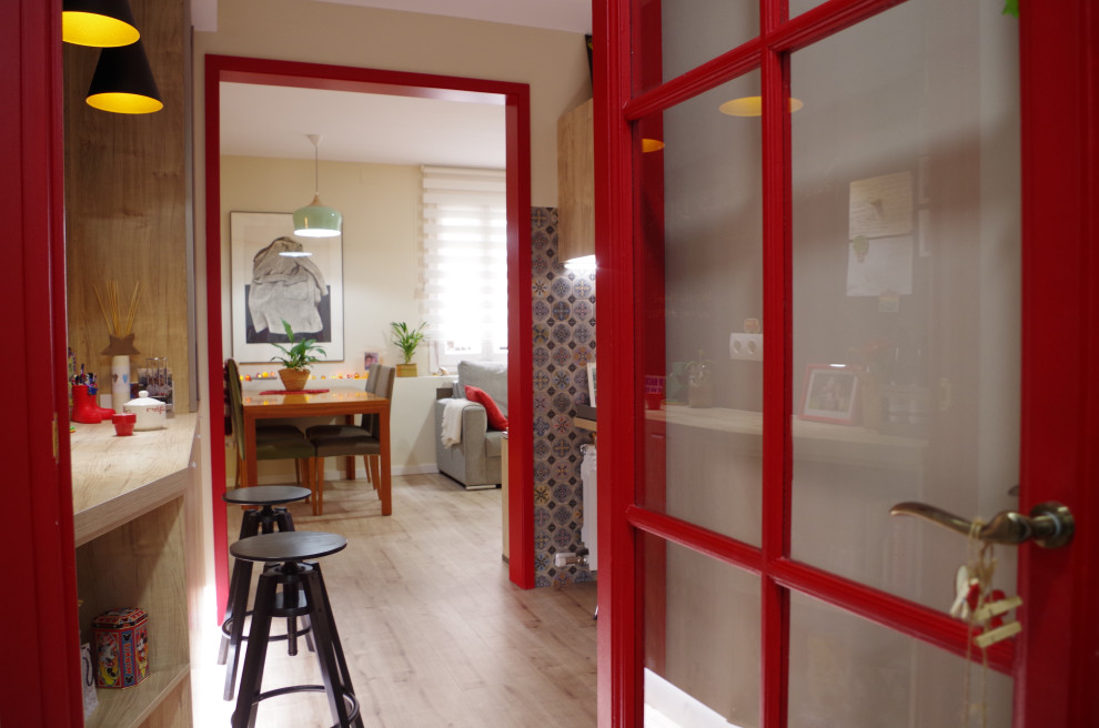 На фото: прихожая в стиле ретро с полом из ламината, красной входной дверью и коричневым полом с