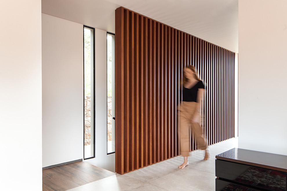 Idee per un ingresso moderno di medie dimensioni con pareti bianche, pavimento in gres porcellanato e pavimento beige