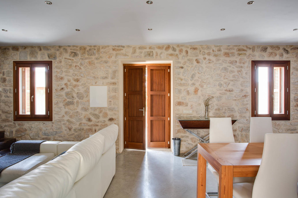 Inspiration for a mediterranean hallway in Other with beige walls, concrete flooring, a double front door, a medium wood front door and grey floors.