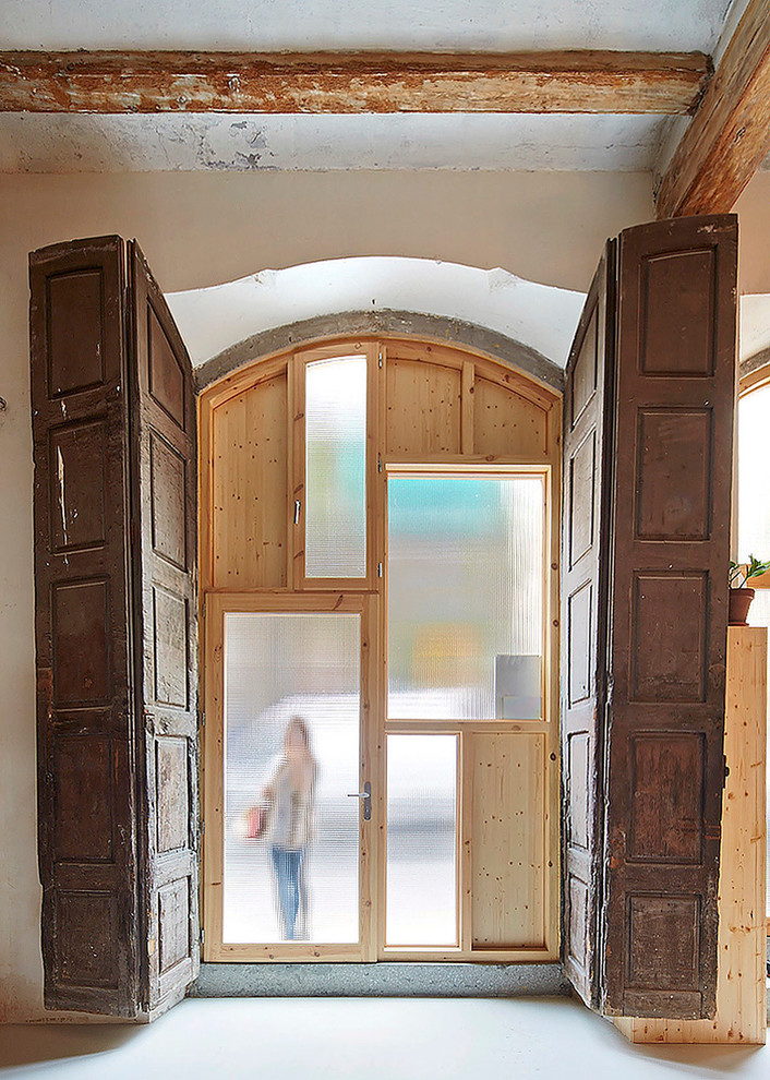 Ejemplo de puerta principal urbana de tamaño medio con paredes blancas, puerta simple y puerta de vidrio