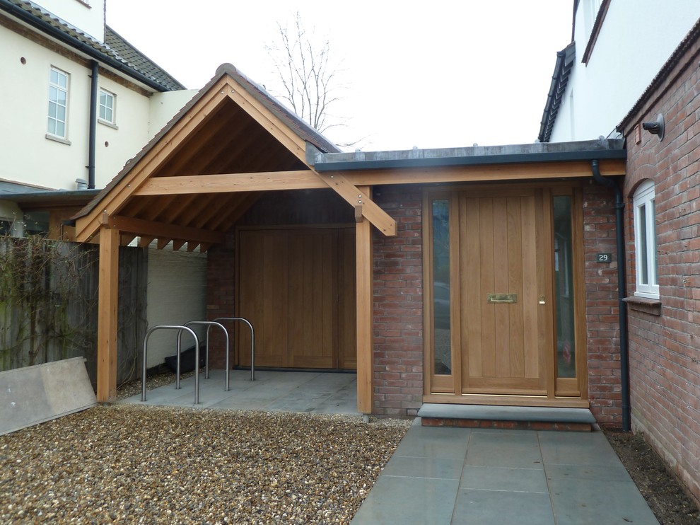 Entryway - large contemporary entryway idea in Cambridgeshire with a medium wood front door