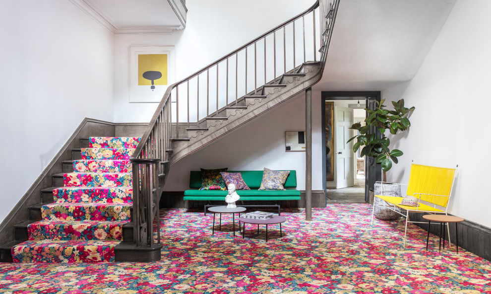 Eclectic carpeted entryway photo in Hampshire with white walls