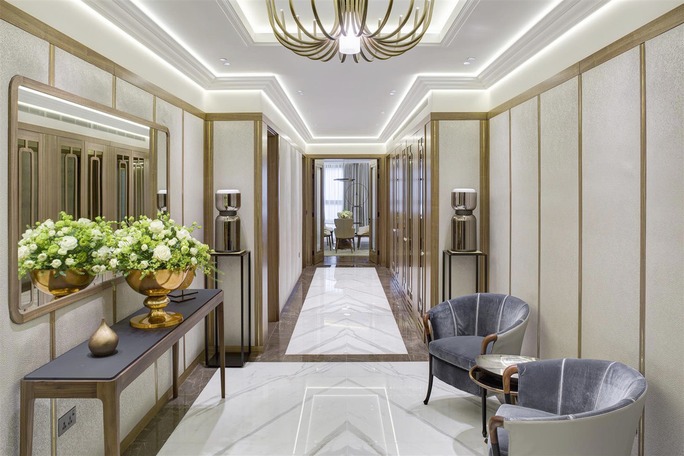 This is an example of a contemporary foyer in London with white walls and white floors.