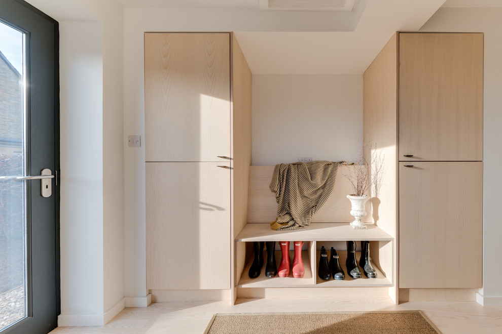 Inspiration for a scandi boot room in Other with white walls, a single front door, a grey front door and beige floors.