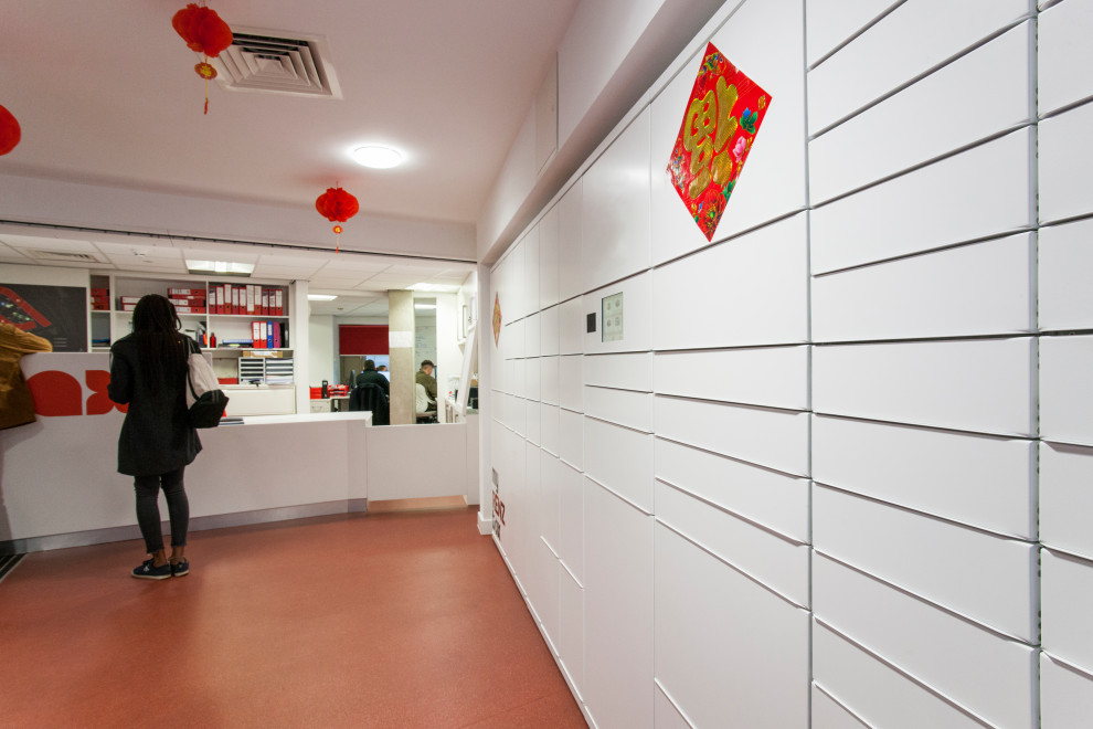 This is an example of a modern foyer in London with white walls and red floors.