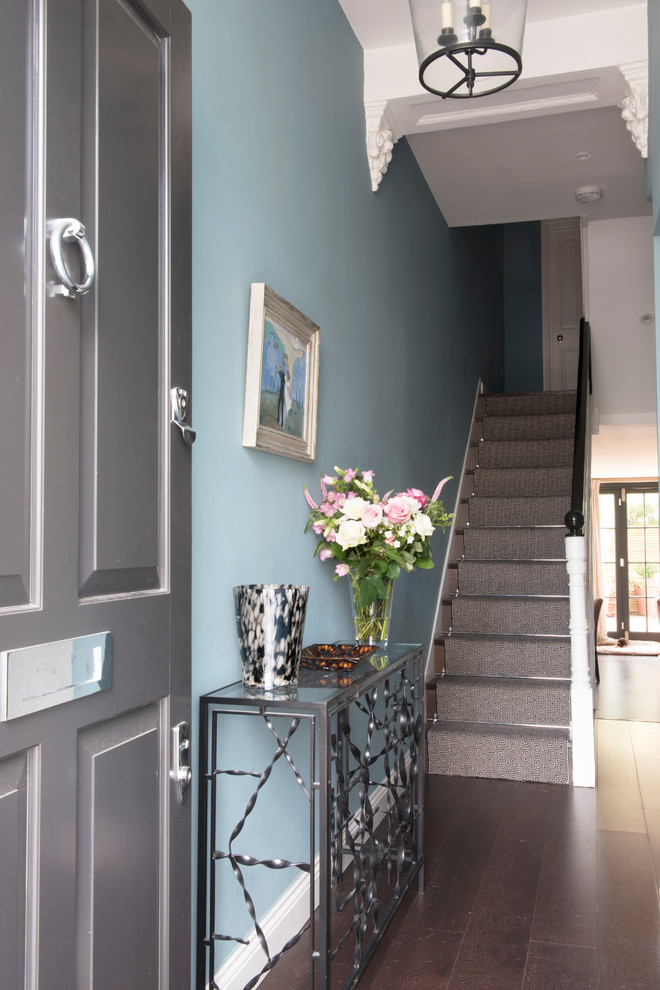 Classic foyer in London with blue walls, dark hardwood flooring, brown floors, a single front door and a grey front door.