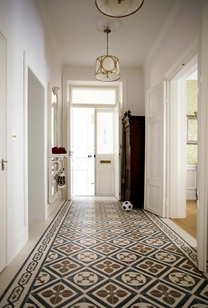 Entry hall - traditional entry hall idea in London with white walls and a white front door