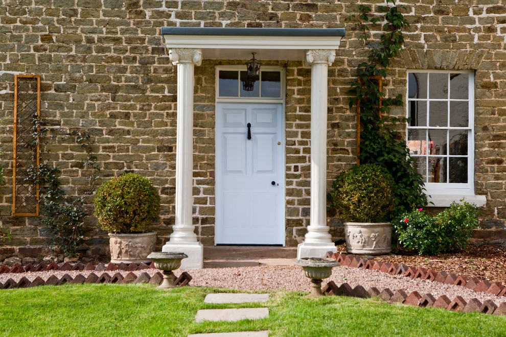 Photo of a medium sized contemporary entrance in London with white walls, medium hardwood flooring, a single front door and a white front door.