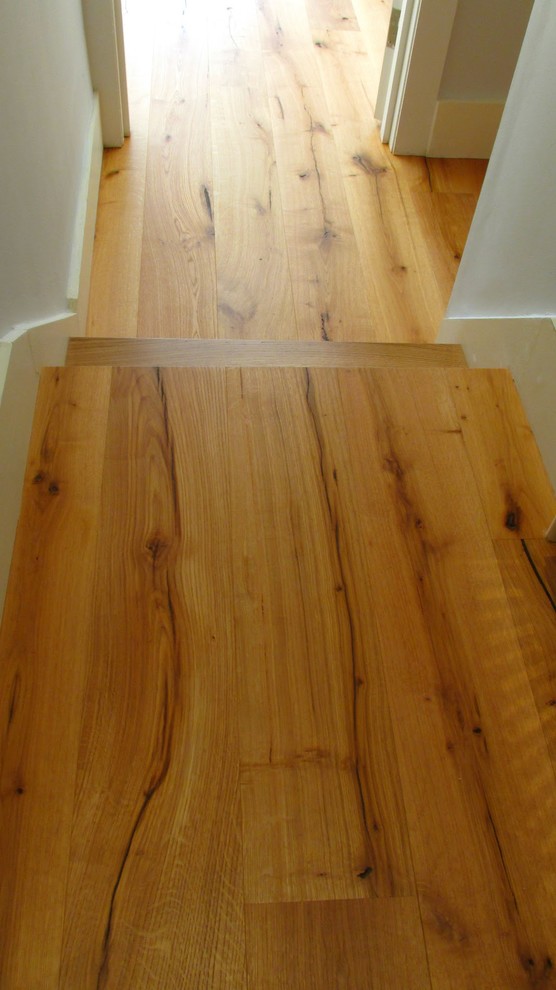 Design ideas for a small coastal front door in London with light hardwood flooring.