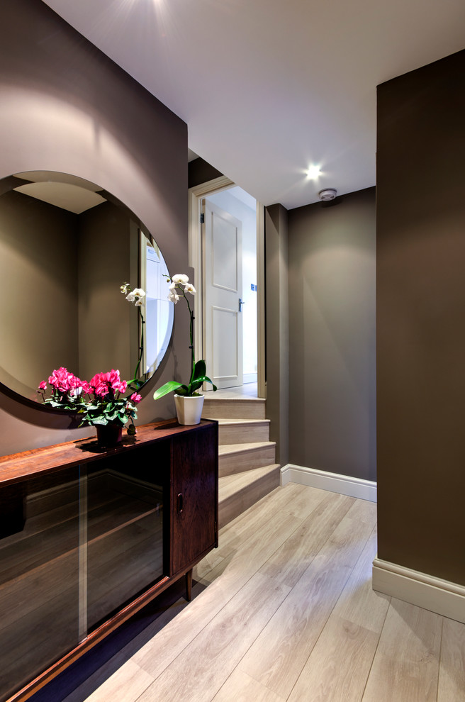 Inspiration for a small traditional hallway in London with brown walls and light hardwood flooring.