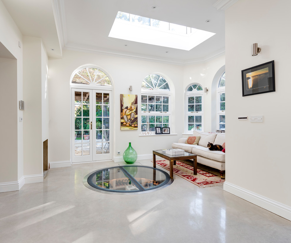 Photo of a medium sized contemporary foyer in London with beige walls, concrete flooring and beige floors.