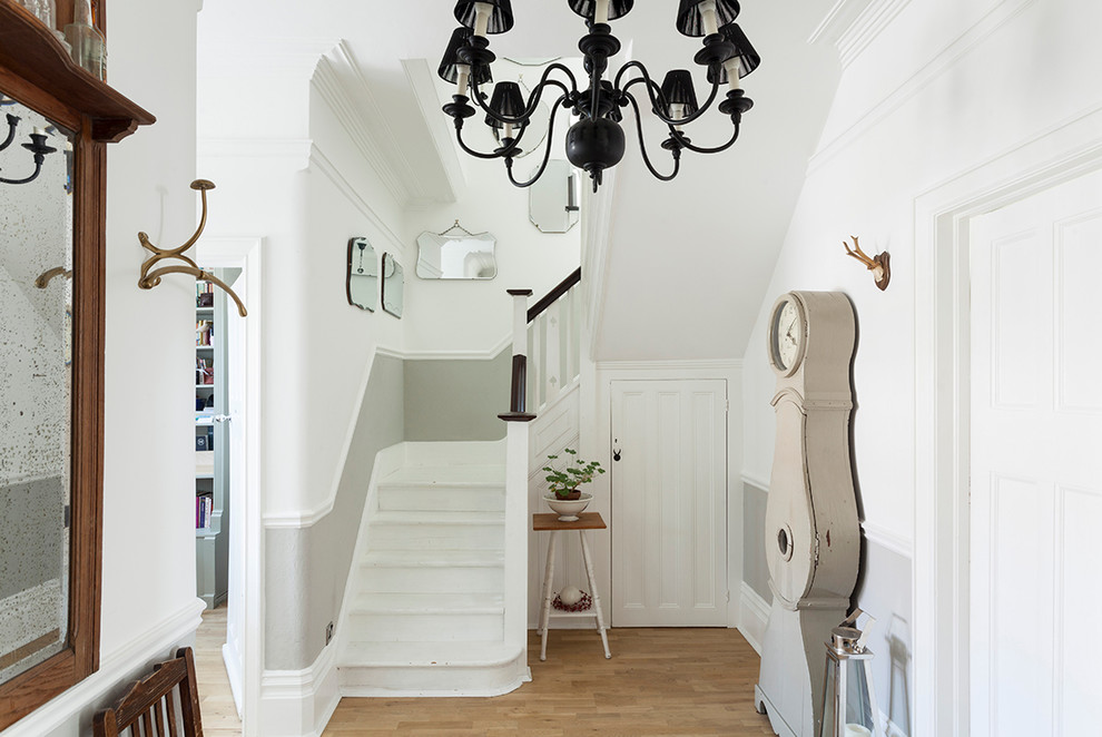 Inspiration for a medium sized traditional entrance in London with light hardwood flooring, beige floors and white walls.