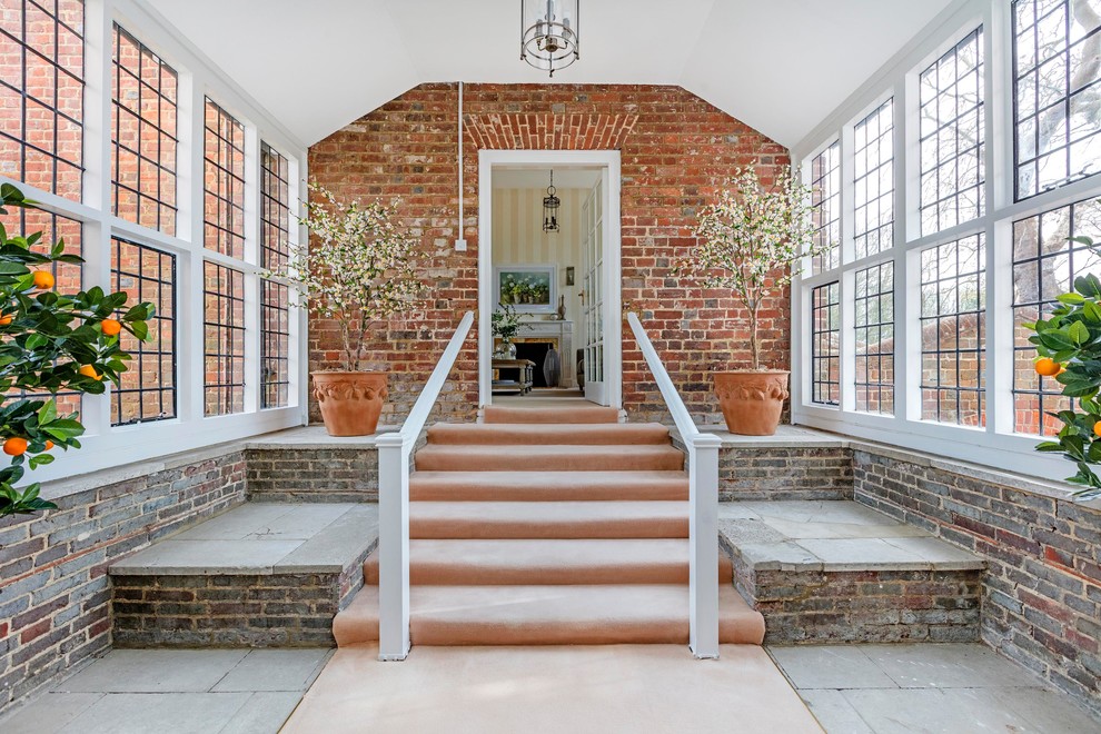 Design ideas for a large classic entrance in London with grey floors and red walls.