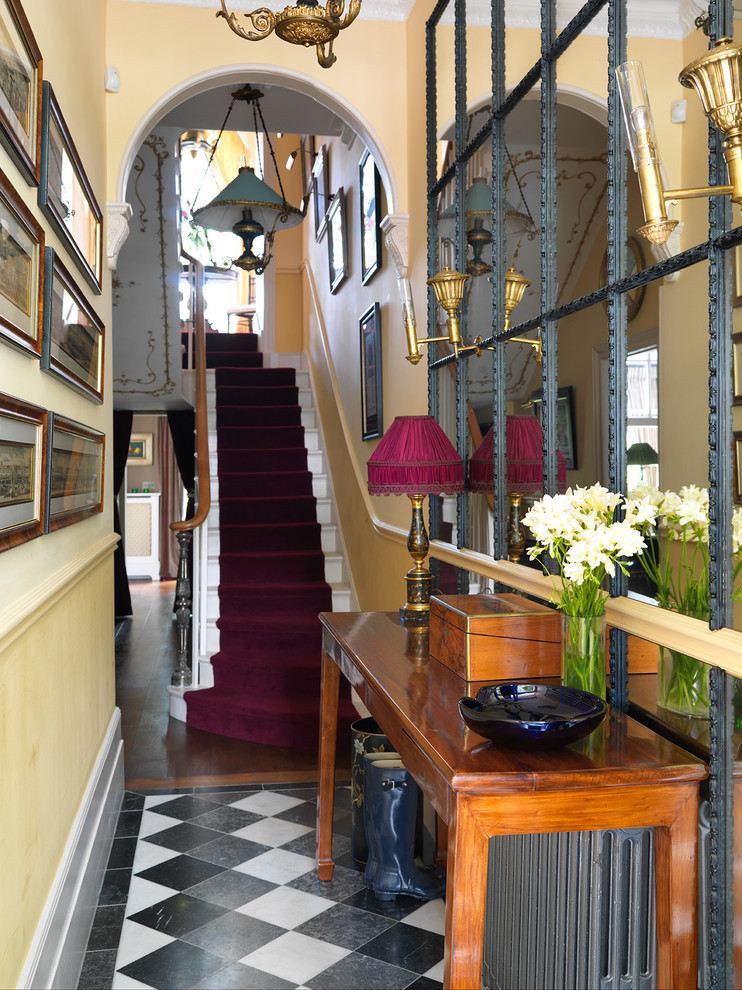 This is an example of a victorian foyer in London with yellow walls and a dado rail.