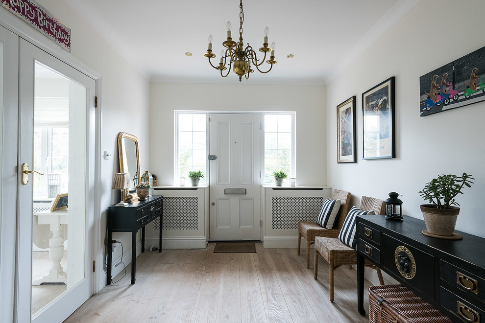 Inspiration for a medium sized traditional entrance in London with light hardwood flooring, a single front door and a white front door.