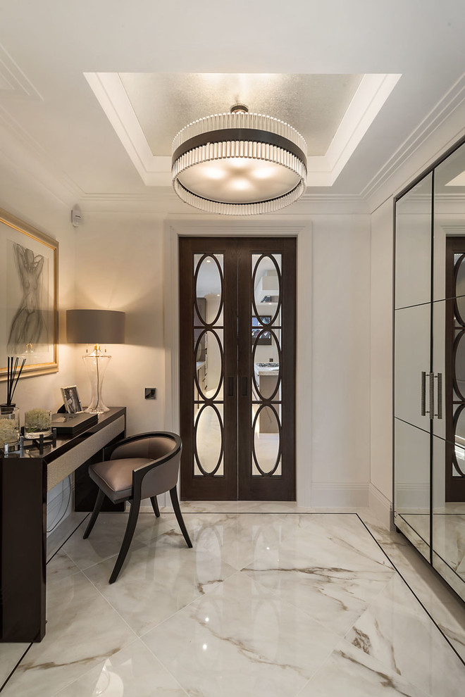 Photo of a classic vestibule in London with white walls and feature lighting.