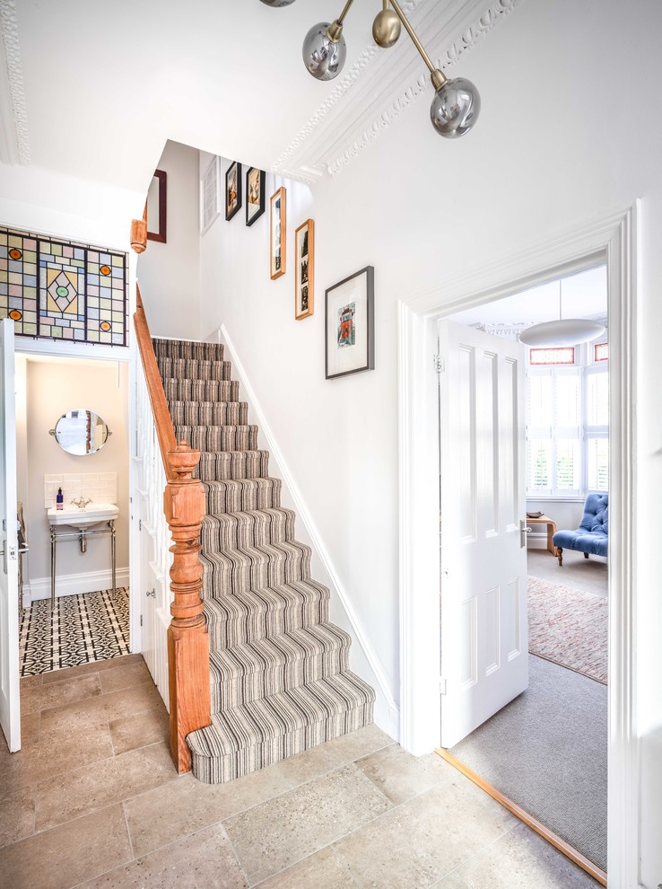 Photo of a small contemporary hallway in Other with white walls, porcelain flooring, a single front door, a white front door and grey floors.