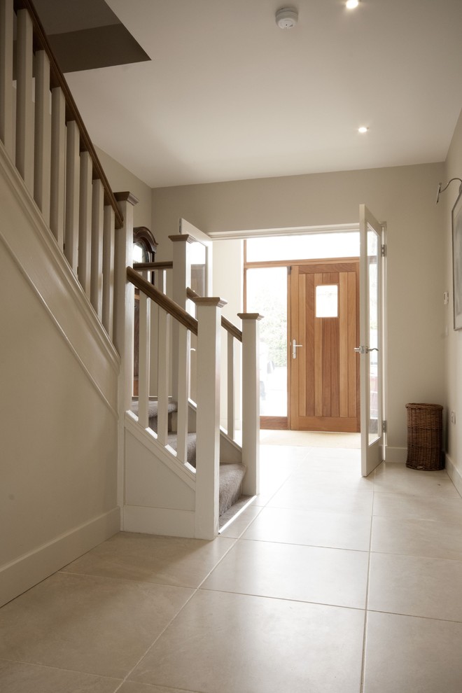 Photo of a medium sized contemporary front door in Dublin with white walls, porcelain flooring, a single front door and a medium wood front door.