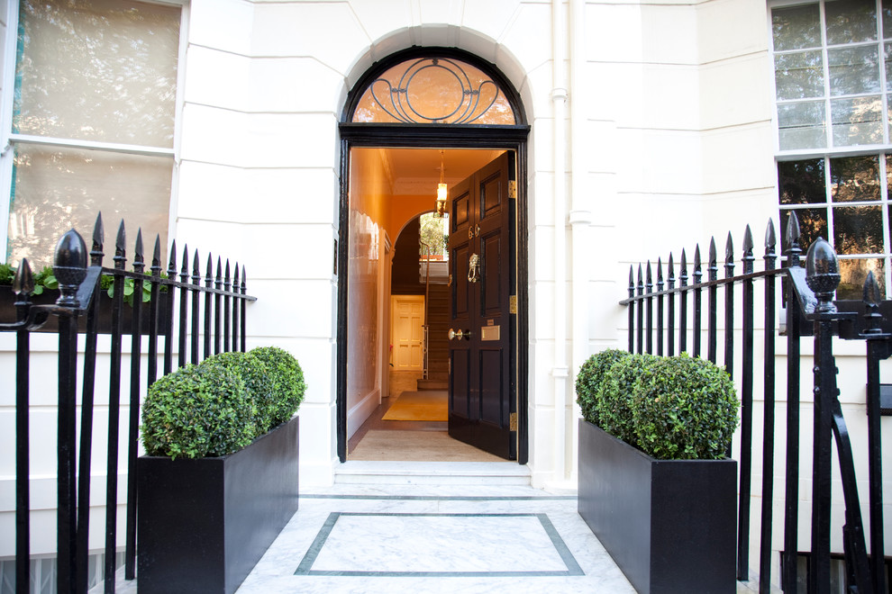 Large traditional front door in London with a single front door and a black front door.