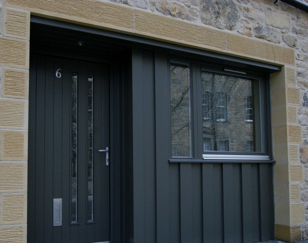 This is an example of a medium sized contemporary front door in Other with purple walls and a grey front door.