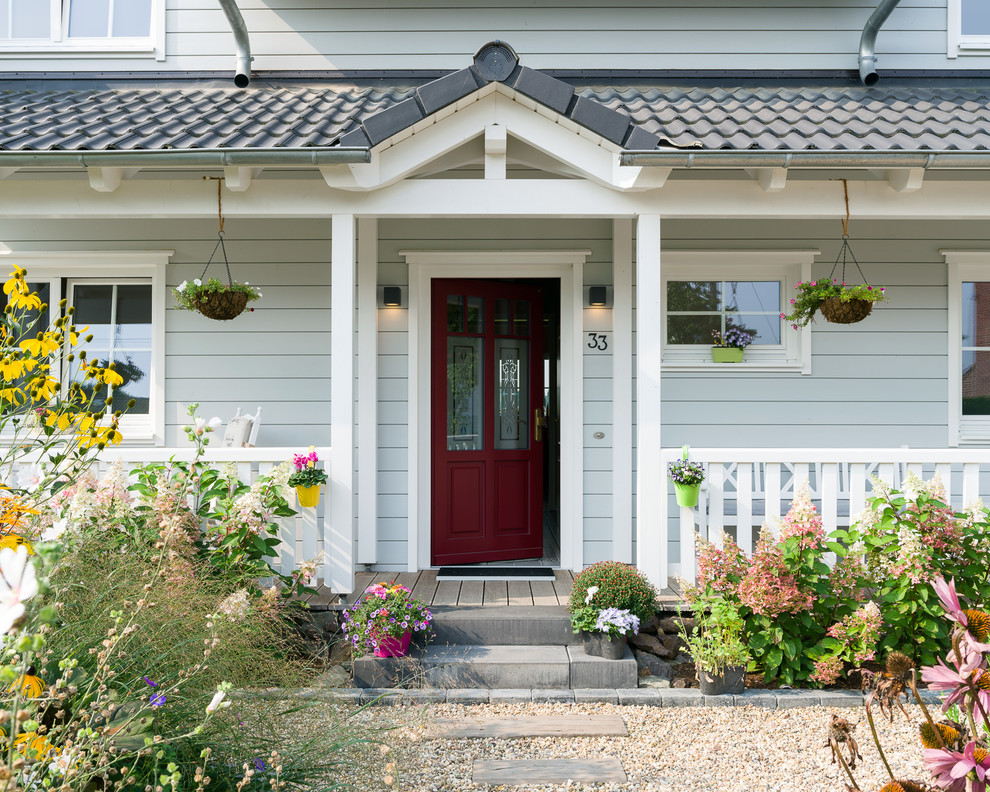 Idée de décoration pour une porte d'entrée champêtre de taille moyenne avec un mur gris, parquet peint, une porte simple, une porte rouge et un sol beige.