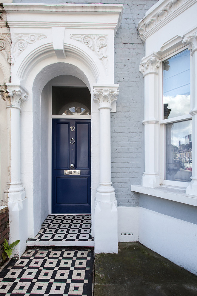 Inspiration för klassiska ingångspartier, med grå väggar, klinkergolv i keramik, en enkeldörr och en blå dörr