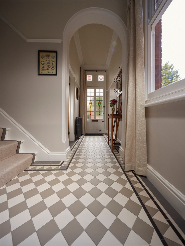 This is an example of a large traditional hallway in Other with beige walls, a single front door, a white front door and beige floors.