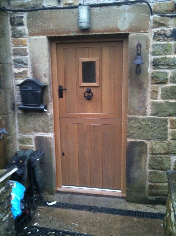 Inspiration for a traditional entrance in Other with a single front door and a medium wood front door.