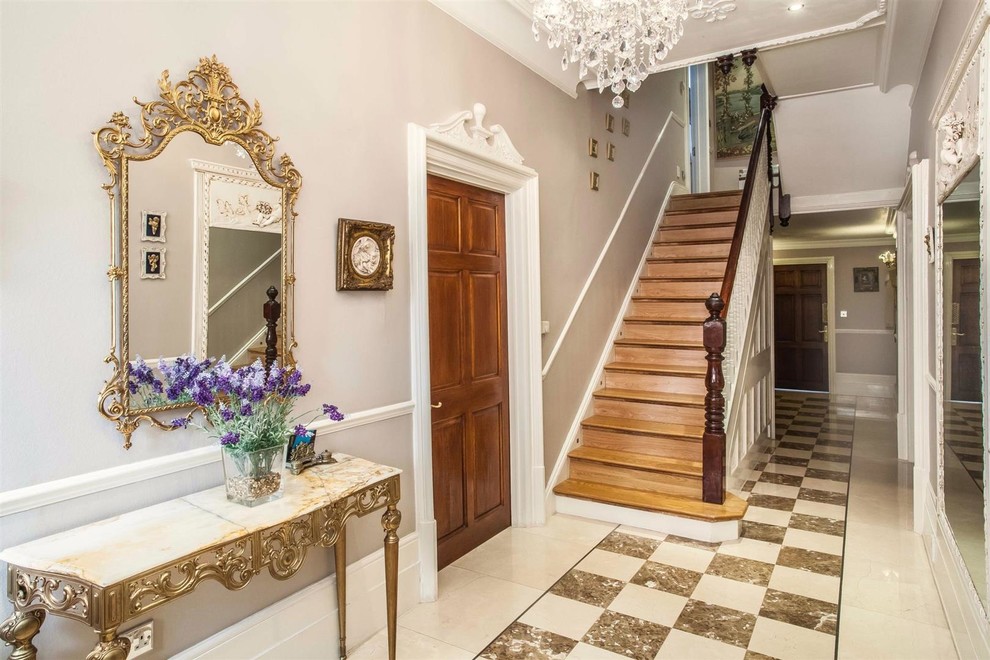 Medium sized traditional entrance in Hertfordshire with beige walls and marble flooring.