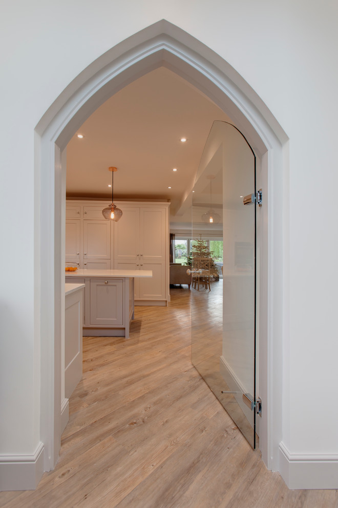 Design ideas for a medium sized classic vestibule in Other with white walls, light hardwood flooring, a single front door and a medium wood front door.