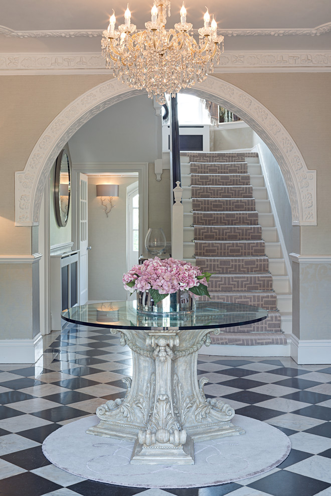 Photo of a large traditional foyer in Sussex with beige walls and ceramic flooring.