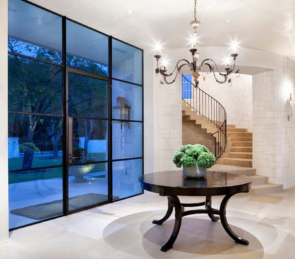 Mediterranean foyer in New York with a single front door and a glass front door.