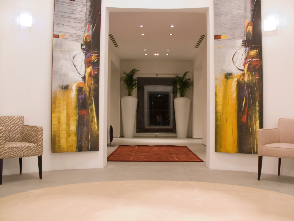 Example of a large minimalist porcelain tile, white floor, coffered ceiling and wallpaper entryway design in Other with white walls and a dark wood front door